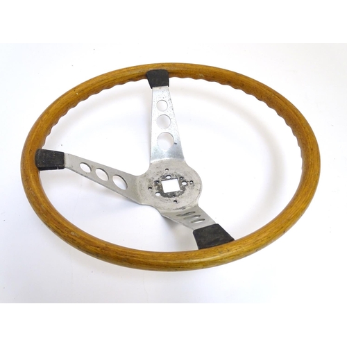 132 - A c1960s wooden and alloy steering wheel by Formula GT Britain, 15'' diameter, 4 1/2'' high