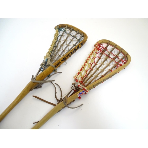 135 - Two old lacrosse rackets, marked ' T.S. Hattersley's, Viktoria, made in England ' . Approx 43'' long