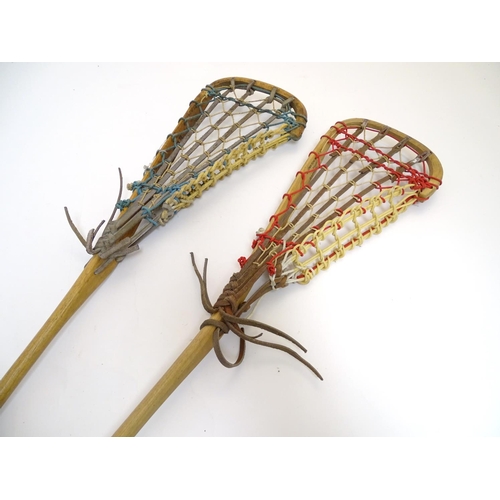 135 - Two old lacrosse rackets, marked ' T.S. Hattersley's, Viktoria, made in England ' . Approx 43'' long