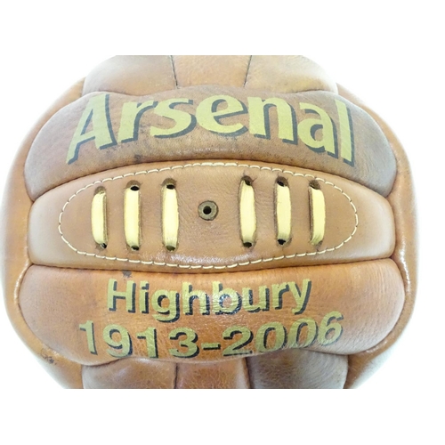 148 - A commemorative leather football on stand, ' Arsenal Highbury 1913-2006 '