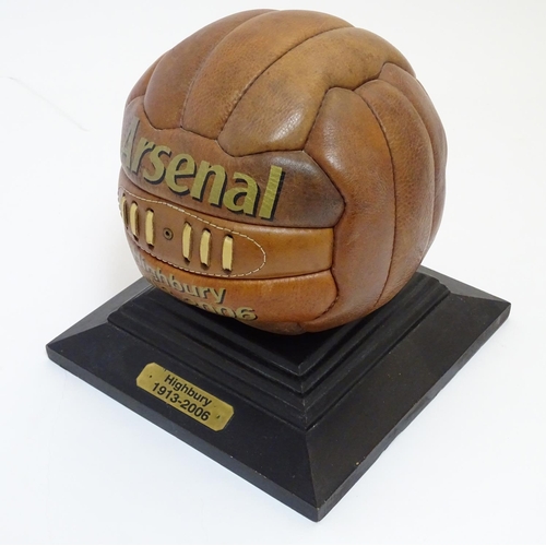 148 - A commemorative leather football on stand, ' Arsenal Highbury 1913-2006 '