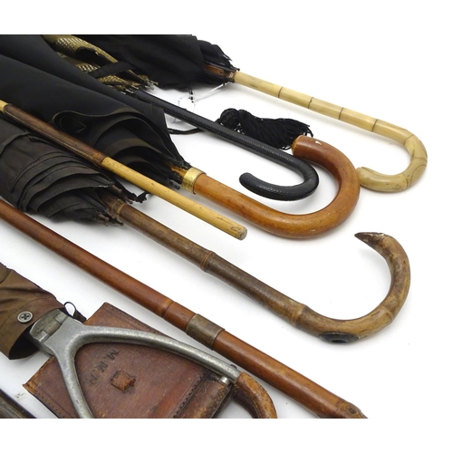 196 - A quantity of assorted sticks , umbrellas etc to include a horn handled cane with hallmarked silver ... 