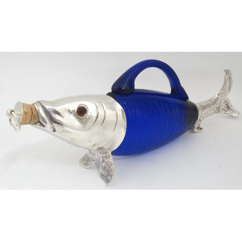 201 - A novelty claret jug / decanter formed as a fish with blue glass body, silver plated mounts and glas... 