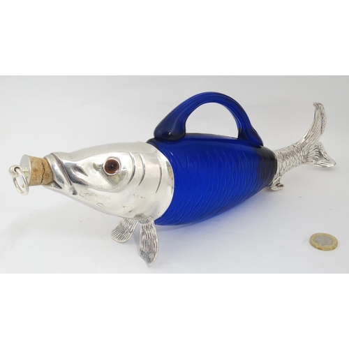 201 - A novelty claret jug / decanter formed as a fish with blue glass body, silver plated mounts and glas... 