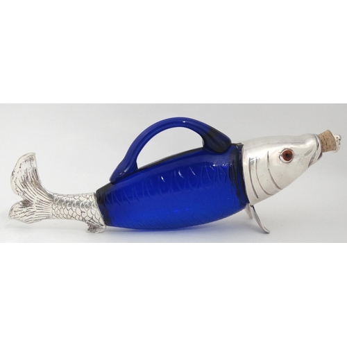 201 - A novelty claret jug / decanter formed as a fish with blue glass body, silver plated mounts and glas... 