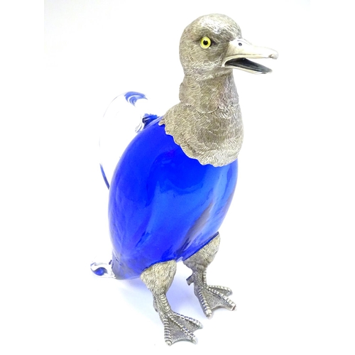 211 - A 21stC novelty claret jug formed as a duck with blue glass body, clear glass handle and silver plat... 