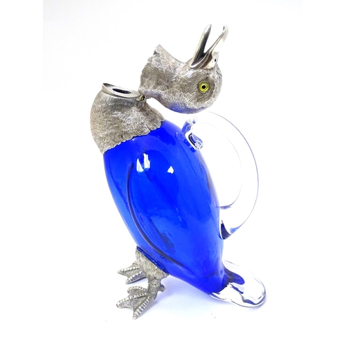 211 - A 21stC novelty claret jug formed as a duck with blue glass body, clear glass handle and silver plat... 