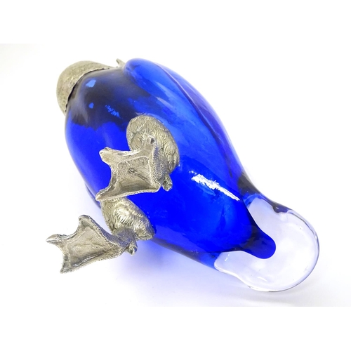 211 - A 21stC novelty claret jug formed as a duck with blue glass body, clear glass handle and silver plat... 