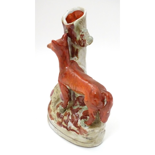 212 - A Staffordshire flat backed fox and game bird spill vase, 8'' high, 5 1/2'' wide