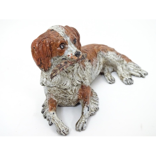 216 - A 21stC novelty cold painted bronze inkwell formed as a recumbent dog with feather to mouth, and hea... 