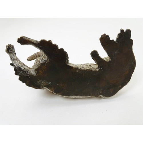 216 - A 21stC novelty cold painted bronze inkwell formed as a recumbent dog with feather to mouth, and hea... 