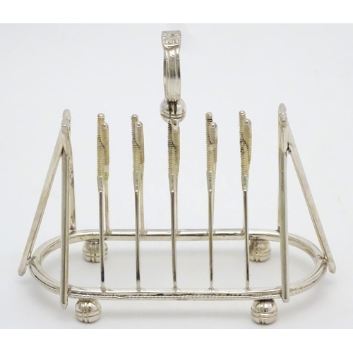 217 - A 21stC silver plate novelty toast rack, formed with crossed cricket bat decoration and stumps to ei... 