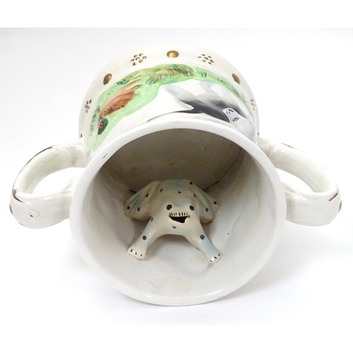 218 - A Staffordshire Loving Mug / Frog mug, depicting relief's of gun dogs and game birds across body and... 