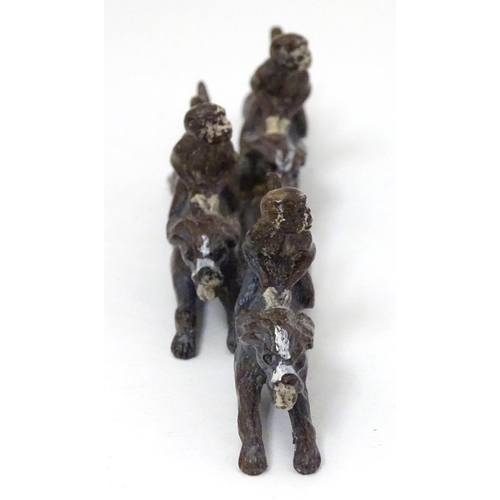 224 - A 21stC cold painted figure group formed as 3 monkeys riding 3 hound dogs. Approx 5'' long x 1 1/2''... 