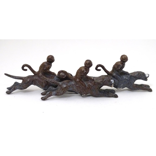 224 - A 21stC cold painted figure group formed as 3 monkeys riding 3 hound dogs. Approx 5'' long x 1 1/2''... 