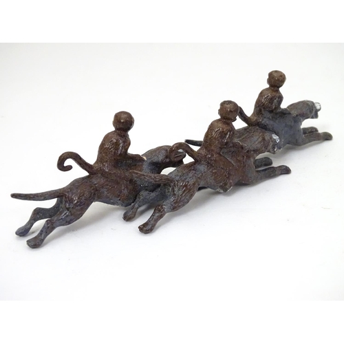 224 - A 21stC cold painted figure group formed as 3 monkeys riding 3 hound dogs. Approx 5'' long x 1 1/2''... 