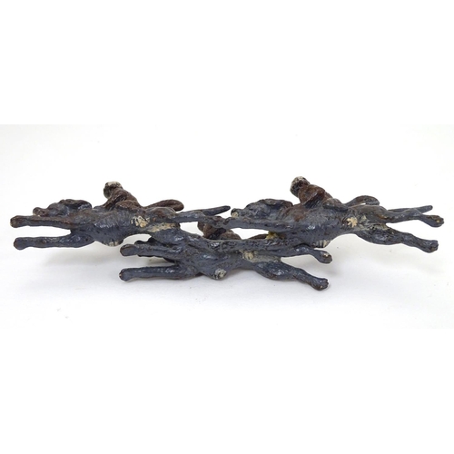 224 - A 21stC cold painted figure group formed as 3 monkeys riding 3 hound dogs. Approx 5'' long x 1 1/2''... 