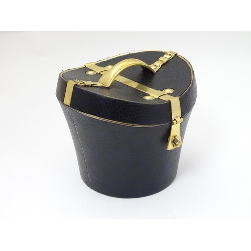 226 - A 21stC novelty brass caddy / container formed as a saddle shaped hat box with black leather coverin... 