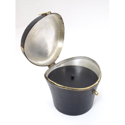 226 - A 21stC novelty brass caddy / container formed as a saddle shaped hat box with black leather coverin... 