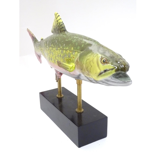 232 - A large hand painted ceramic figure in the form of a trout on a display stand, 10 1/2'' high 17 3/4'... 