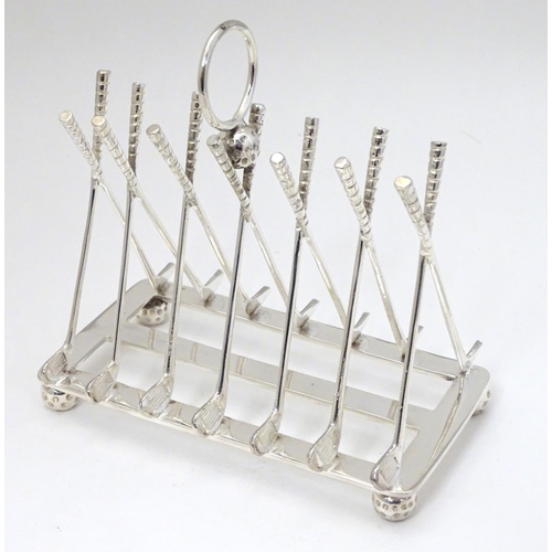 234 - A 21stC silver plate novelty toast rack, bars formed as crossed golf clubs and standing on 4 golf ba... 