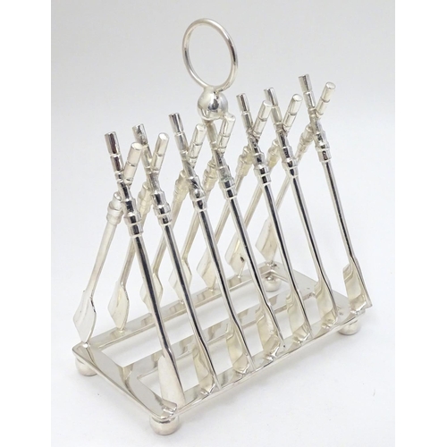 245 - A 21stC silver plate novelty toast rack, the bars formed as crossed oars. Approx 6 1/2'' long x 7 1/... 