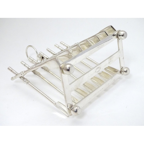 245 - A 21stC silver plate novelty toast rack, the bars formed as crossed oars. Approx 6 1/2'' long x 7 1/... 