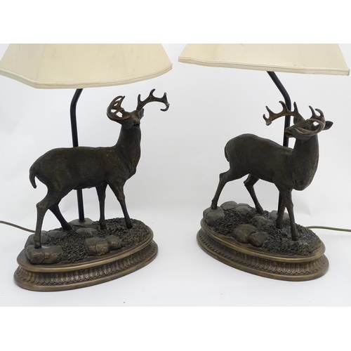 248 - A pair of late 20thC / 21stC table lamps, the bases with white-tail buck /stag decoration on ovoid b... 