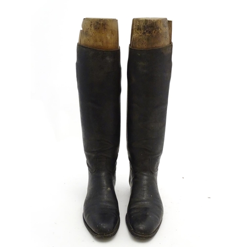 296 - An old pair of gentleman's black leather riding boots, together with trees. The boots approx size 11