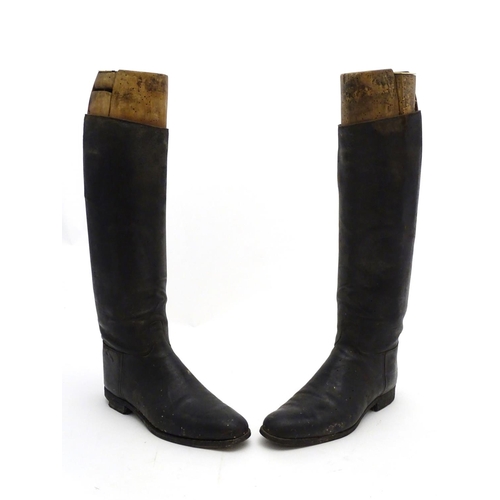 296 - An old pair of gentleman's black leather riding boots, together with trees. The boots approx size 11