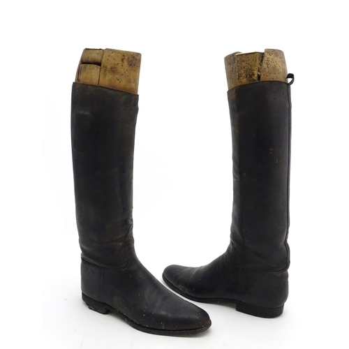 296 - An old pair of gentleman's black leather riding boots, together with trees. The boots approx size 11