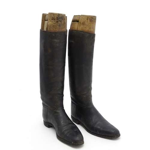 296 - An old pair of gentleman's black leather riding boots, together with trees. The boots approx size 11