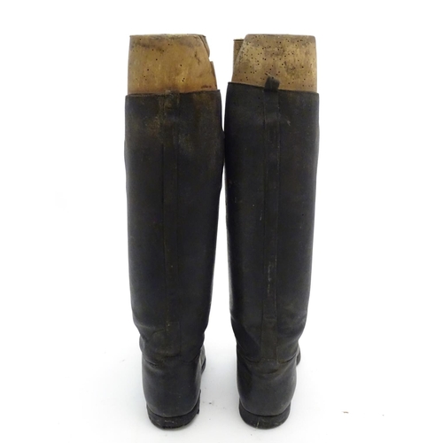 296 - An old pair of gentleman's black leather riding boots, together with trees. The boots approx size 11