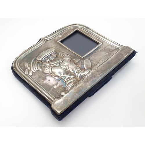 326 - A silver photograph frame having comical golfing figure decoration to one side. Hallmarked Sheffield... 