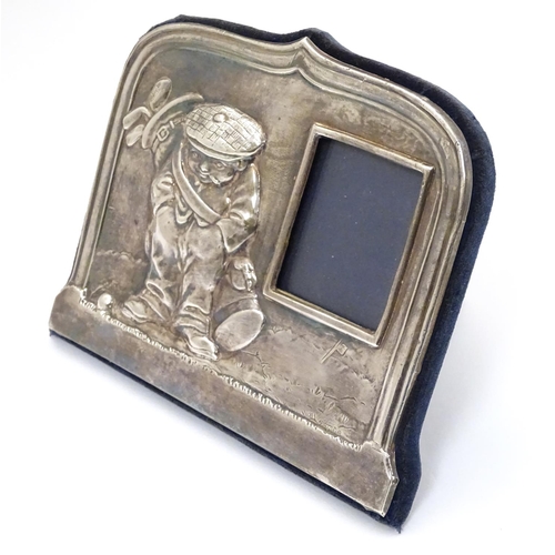 326 - A silver photograph frame having comical golfing figure decoration to one side. Hallmarked Sheffield... 