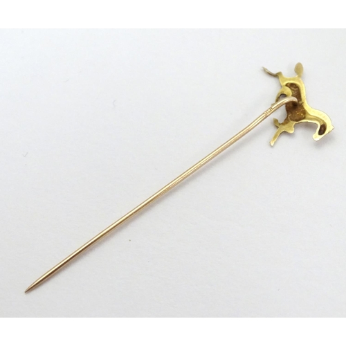 326A - A gold and yellow metal stick pin surmounted by a horse. Marked 10k. Approx 2 3/4'' long overall