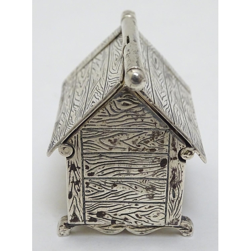 384 - A novelty silver vesta case formed as a dog kennel / dog house  with sprung action to roof, striker ... 