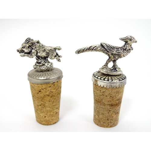 385 - 2 cork bottle stoppers, surmounted by silver plate decoration of a pheasant and a boar. Each approx ... 