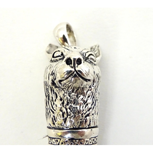 390 - A 21stC silver novelty whistle with hare head decoration. 1 3/4'' high