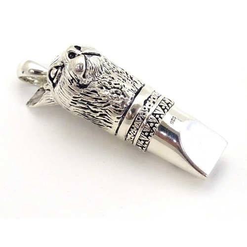 390 - A 21stC silver novelty whistle with hare head decoration. 1 3/4'' high