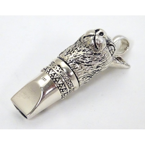 390 - A 21stC silver novelty whistle with hare head decoration. 1 3/4'' high