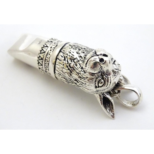 390 - A 21stC silver novelty whistle with hare head decoration. 1 3/4'' high