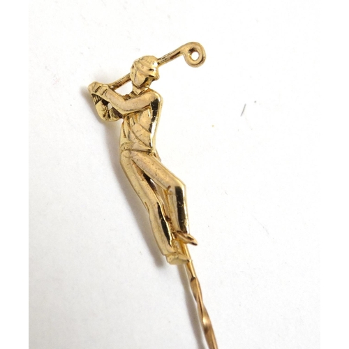 395 - A gilt metal stick pin surmounted by a golfer