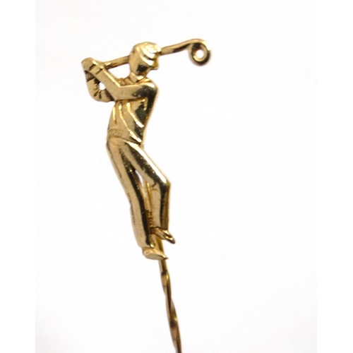 395 - A gilt metal stick pin surmounted by a golfer