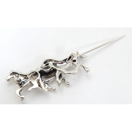 398 - A brooch with 3 galloping horse decoration. Marked '925' 1 3/4'' wide