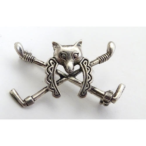 399 - A brooch with riding crop, horse shoe and fox head decoration. Marked 'Sterling' 1 1/4'' wide