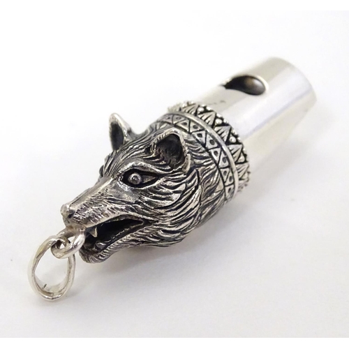 402 - A 21stC silver novelty whistle with fox head decoration. 1 1/2'' long