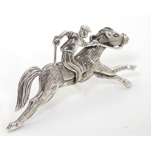 411 - A brooch formed as a racehorse and jockey. 2 1/4'' long