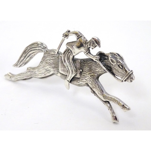 411 - A brooch formed as a racehorse and jockey. 2 1/4'' long