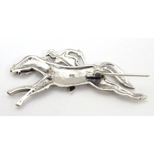 411 - A brooch formed as a racehorse and jockey. 2 1/4'' long